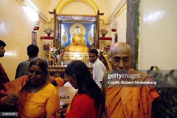 Buddhist monk walks through a crowd of Hindu pilgrims and worshippers in the Mahabodhi Temple July 24, 2005 in Bodhgaya, India. The temple is next to...