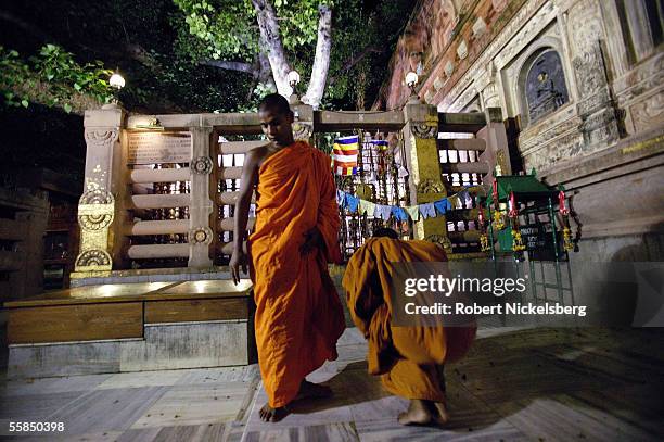 Two Buddhist monks leave after praying beneath the Bodhi Tree July 24, 2005 in Bodhgaya, India. Buddha attained enlightenment following years of...