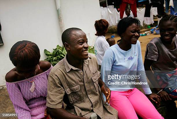 Joseph Duo a former Liberian government soldier, jokes with friends in his neighborhood October 5, 2005 in Monrovia, Liberia. A picture of Duo...