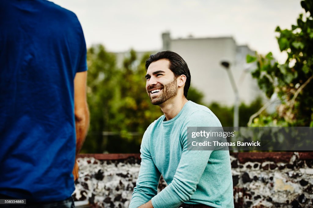 Man in discussion with friends during party