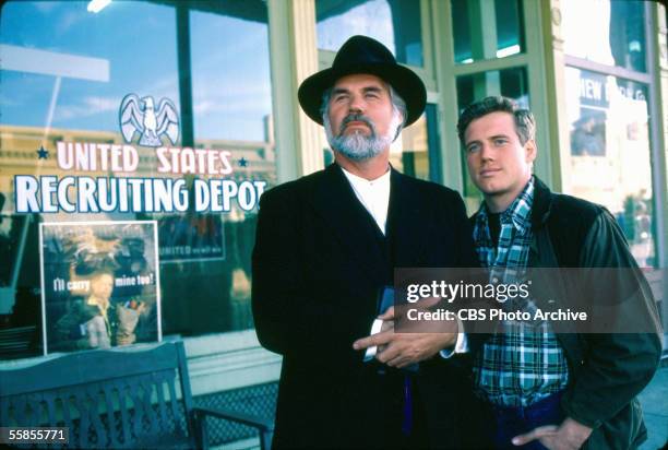 American musician and actor Kenny Rogers stands in costume as Uncle Matthew Spencer alongside colleague Frederic Lehne in a publicity photo for the...