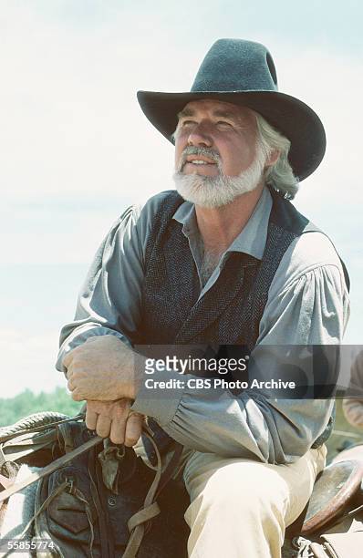 American musician and actor Kenny Rogers sits in the saddle in character as Brady Hawkes in a publicity photo for the CBS televison movie 'The...