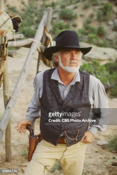 American musician and actor Kenny Rogers stands with his hand on the grip of his pistol in character as Brady Hawkes in a publicity photo for the CBS...