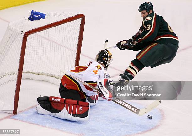 Calgary Flames goalie Miikka Kiprusoff stops the shot from Matt Foy of the Minnesota Wild, the shot was put into the net immediately after during...