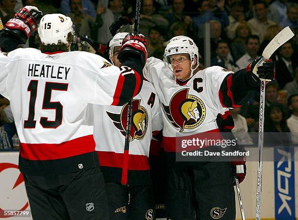 Daniel Alfredsson of the Ottawa Senators celebrates his first goal with teammates Wade Redden and Dany Heatley during their NHL game at the Air...