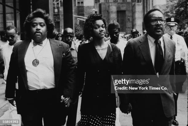 American religious leader and civil rights activist Reverrend Al Sharpton , Tawana Brawley, and attorney C. Vernon Mason, hold hands outside the...