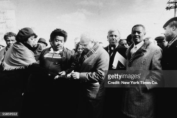 American religious leader and civil rights activist Reverrend Al Sharpton and NAACP executive director Benjamin L Hooks accept candles from lawyer...