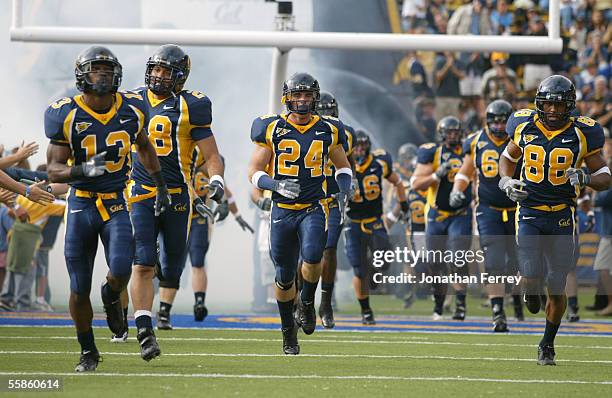 Brandon Hampton, Kenny Frank, Kenny Green, Eddie Young of the California Golden Bears run onto the field before the game against the Arizona Wildcats...