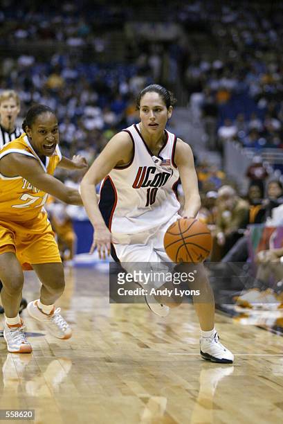 Sue Bird of Connecticut drives around Loree Moore of Tennessee during the NCAA Women's Final Four game at the Alamo Dome in San Antonio, Texas....