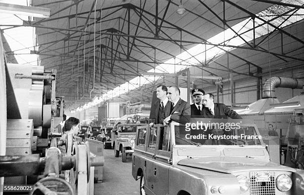 Une manière originale, sans quitter sa voiture, Georges Pompidou et à ses côtés Olivier Guichard, Commissaire au Plan, visite une grande usine de...