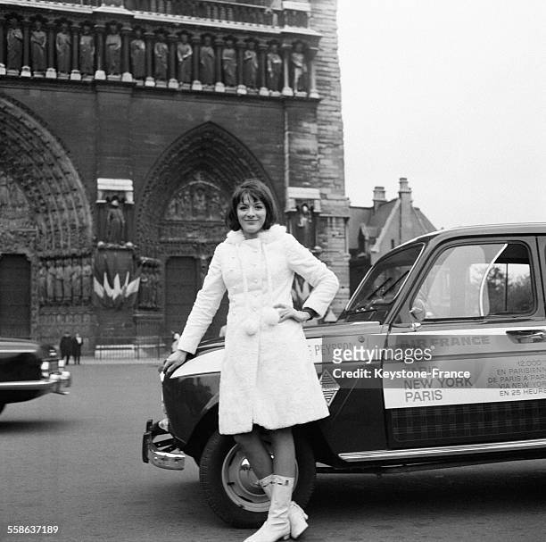 La speakerine Anne-Marie Peysson avec sa voiture devant la Cathédrale Notre-Dame après avoir gagné le pari que lui avait lancé le présentateur Guy...