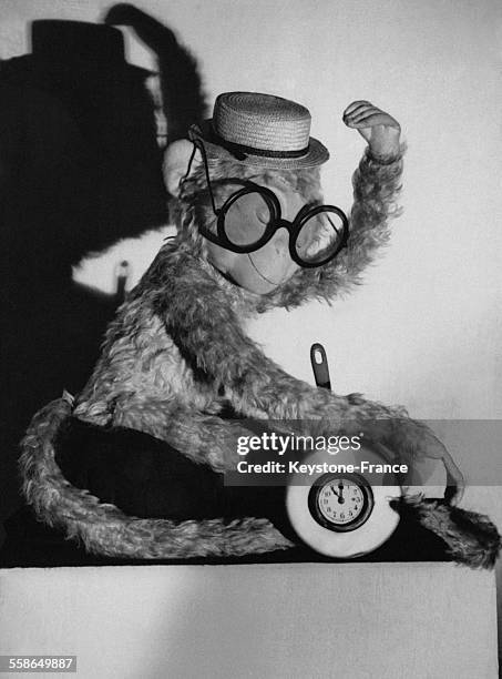 Singe en peluche avec des lunettes et une horloge.