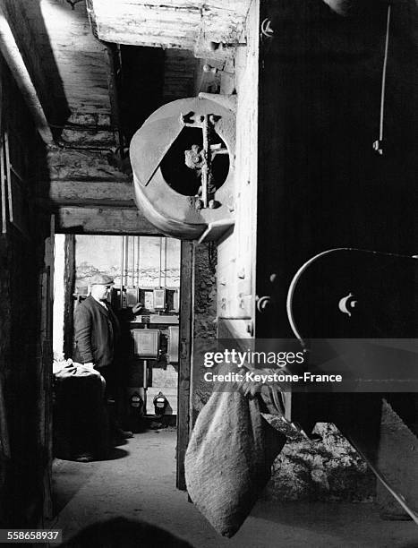 Paysan utilisant l'électricité pour couper l'aliment pour le bétail pour l'hiver, en Ecosse, Royaume-Uni en 1945.