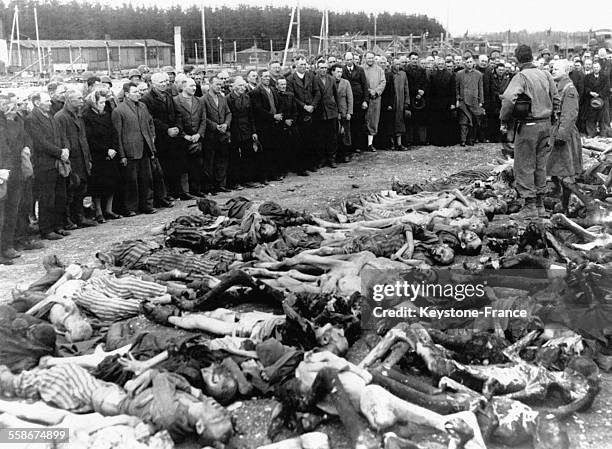 Déportés et charnier lors de la libération du camp de Bergen-Belsen, 4 avril 1945, Belsen, Basse-Saxe, Allemagne.