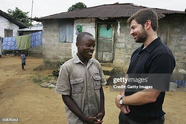 Joseph Duo a former Liberian government soldier, talks with photographer Chris Hondros at his home October 5, 2005 in Monrovia, Liberia. A picture of...