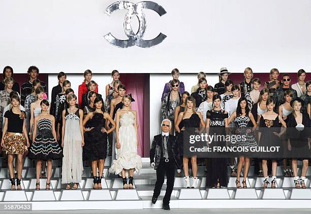 German designer Karl Lagerfeld salutes at the end of his show for Chanel during the Spring/Summer 2006 Ready-to-Wear collections in Paris, 07 October...