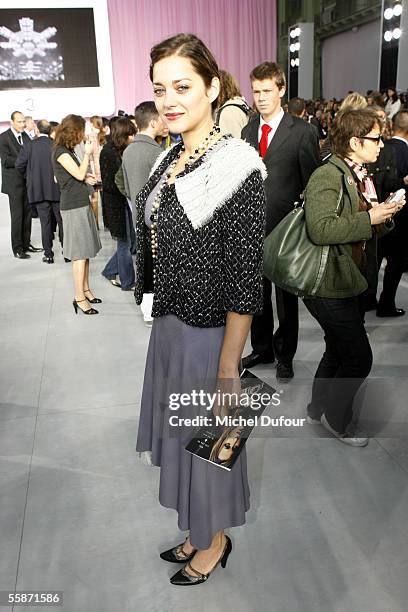 Marion Cotillard watches the Chanel show as part of Paris Fashion Week Spring/Summer 2006 on October 7, 2005 in Paris, France.