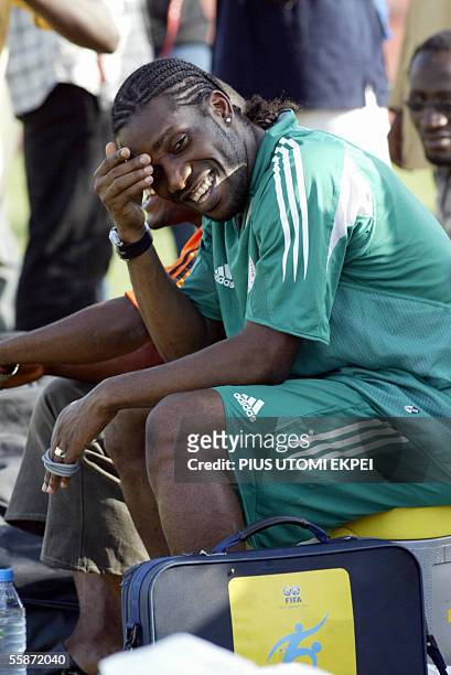 Nigerian skipper Austin Jay Jay Okocha sits watching his colleagues train in Abuja national stadium 07 October, 2005 for their world cup...