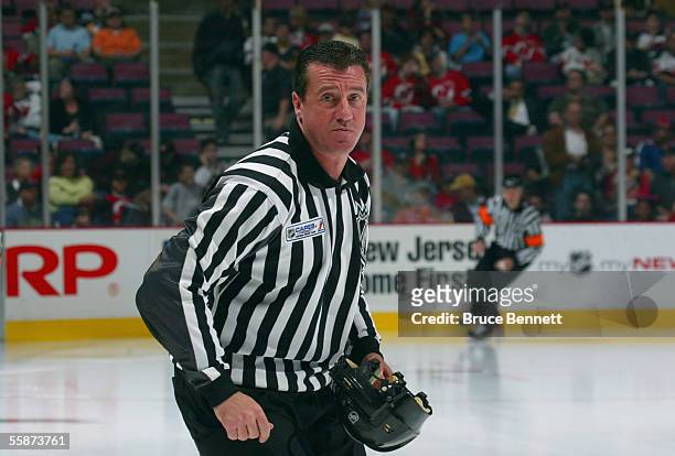 Linesman Pat Dapuzzo skates prior to start of play between the Pittsburgh Penguins and the New Jersey Devils during their NHL opening night game at...