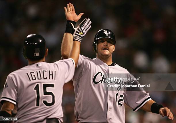 Catcher A.J. Pierzynski of the Chicago White Sox celebrates with teammate Tadahito Iguchi after scoring on a squeeze bunt during the ninth inning of...