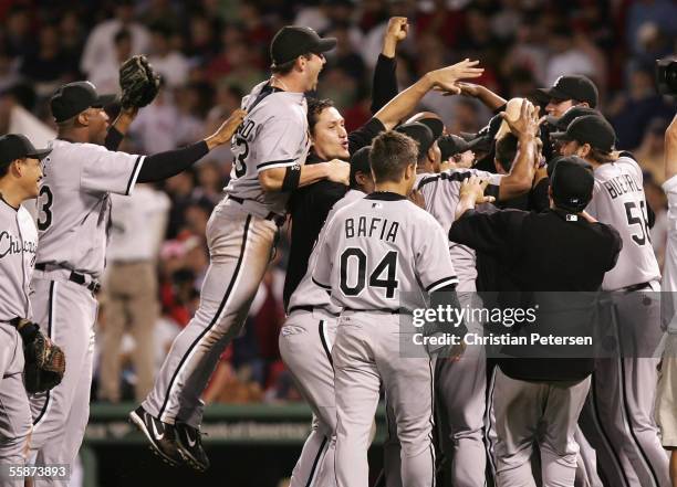 The Chicago White Sox celebrate on the field after winning Game Three of the American League Division Series against the Boston Red Sox at Fenway...