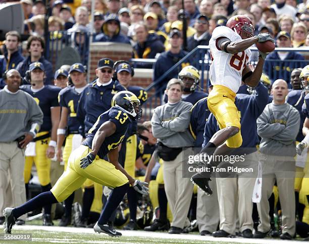 Chris Mensen of Minnesota catches a pass near Grant Mason of Michigan on October 8, 2005 at Michigan Stadium in Ann Arbor, Michigan. The pass was...