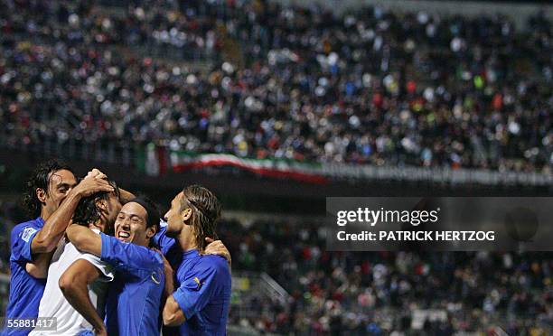 Italian defender Cristian Zaccardo is congratulated by his teammates after scoring against Slovenia during their World Cup 2006 qualifying football...