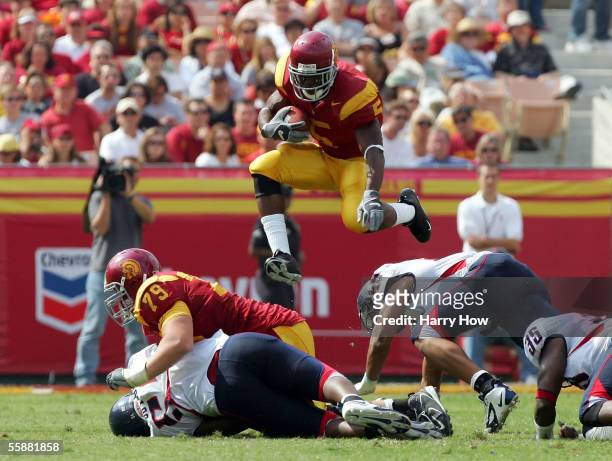Reggie Bush of USC leaps over the Arizona defense during the second quarter at the Los Angeles Colliseum on October 8, 2005 in Los Angeles,...