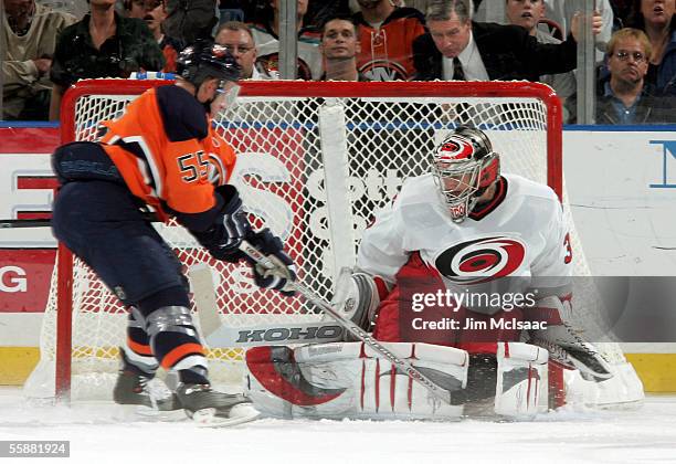 Center Jason Blake of the New York Islanders looks for a rebound against goalie Cam Ward of the Carolina Hurricanes October 8, 2005 at Nassau...