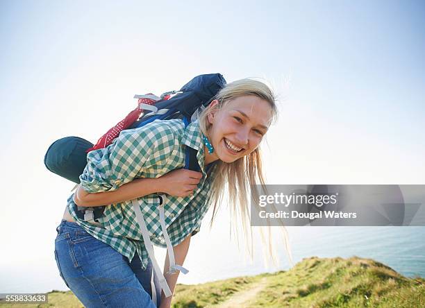 female hiker smiling - rucksacktourist stock-fotos und bilder