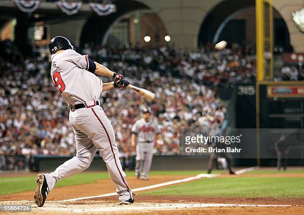 Adam LaRoche of the Atlanta Braves hits a grand-slam home run in the third inning against the Houston Astros in Game Four of the 2005 National League...