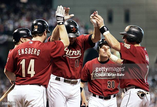 Lance Berkman of the Houston Astros is congratulated by teammates after hitting a grand-slam home run in the eighth inning against the Atlanta Braves...
