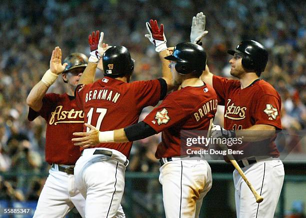 Craig Biggio, Lance Berkman, Eric Bruntlett and Morgan Ensberg of the Houston Astros celebrate Berkman's grand-slam home run in the eighth inning...