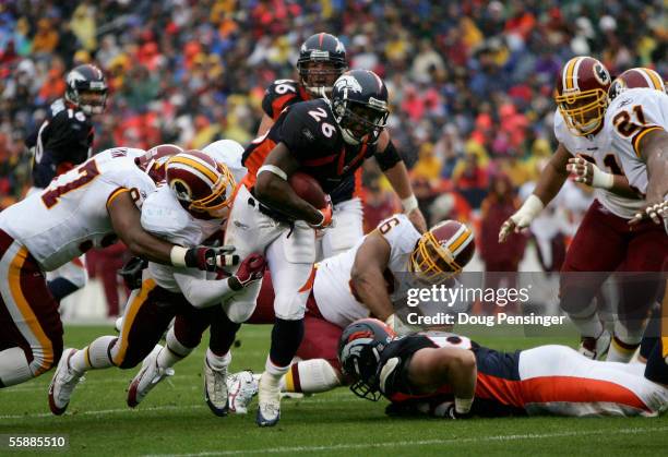 Tatum Bell of the Denver Broncos picks up yardage against the Washington Redskins during NFL action at Invesco Field at Mile High on October 9, 2005...