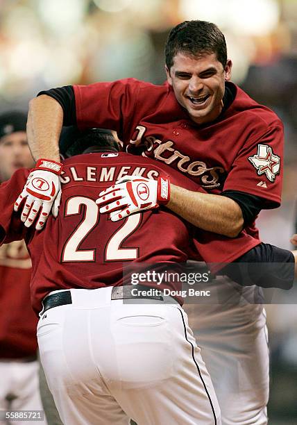 Winning pitcher Roger Clemens of the Houston Astros picks up Chris Burke to celebrate after Burke hit a solo home run to defeat the Atlanta Braves in...