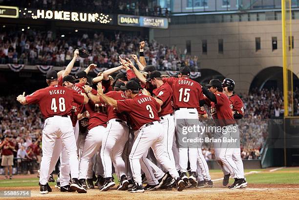 The Houston Astros celebrate after Chris Burke hit a solo home run to defeat the Atlanta Braves in Game Four of the 2005 National League Division...