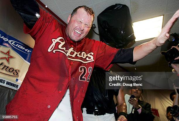 Winning pitcher Roger Clemens of the Houston Astros celebrates with champagne in the locker room after Chris Burke hit a solo home run to defeat the...