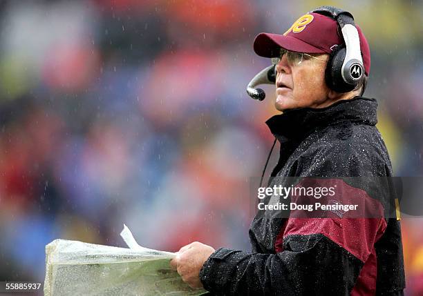 Head coach Joe Gibbs of the Washington Redskins looks on in a cold rain as the Denver Broncos gave his team their first loss of the year as the...