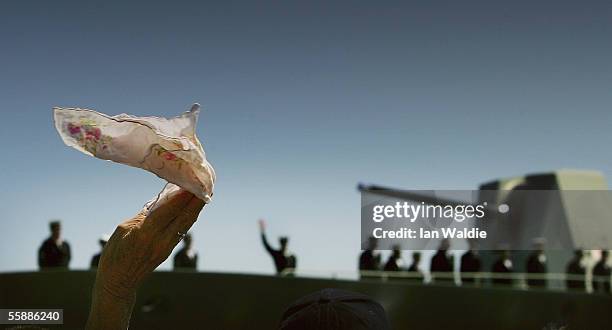 Family member waves goodbye as the HMAS Parramatta departs for the Persian Gulf on October 10, 2005 in Sydney, Australia. The Anzac Class Frigate...