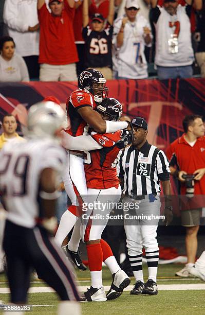 Dez White of the Atlanta Falcons is congratulated by Alge Crumpler after scoring a touchdown against the New England Patriots on October 9, 2005 at...