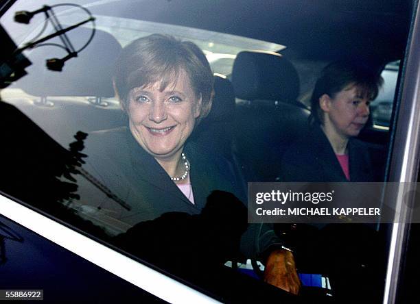 Conservative leader Angela Merkel is accompanied by her office's leader Beate Baumann as she arrives for a meeting with her Christian Democratic...