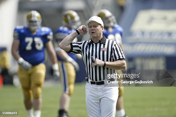 Big East official Gerard McGinn, a referee, signals during a game between the Youngstown State Penguins and University of Pittsburgh Panthers at...