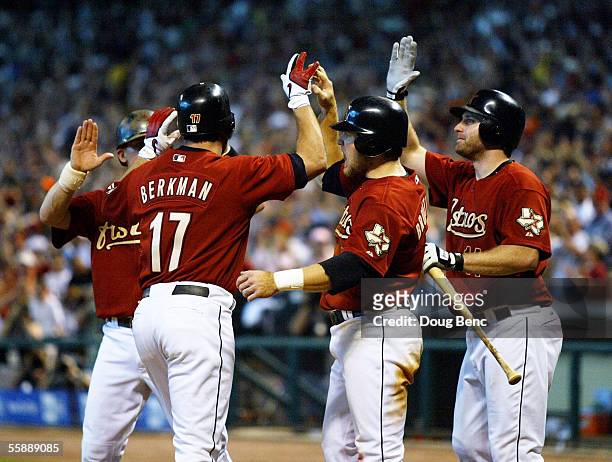 Craig Biggio, Lance Berkman, Eric Bruntlett and Morgan Ensberg of the Houston Astros celebrate Berkman's grand-slam home run in the eighth inning...