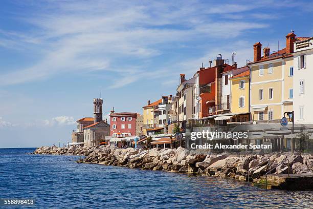 piran lighthouse and houses at the waterfront - piran stock-fotos und bilder