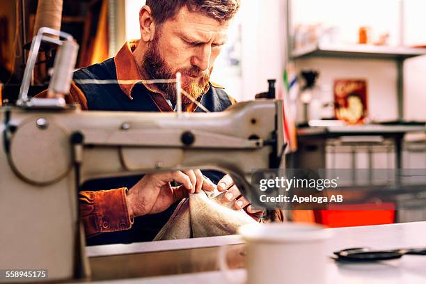 worker holding fabric at sewing table in workshop - checking pockets stock pictures, royalty-free photos & images