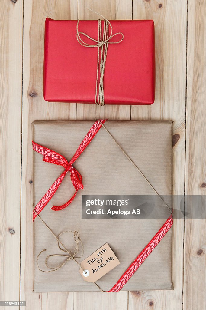 Christmas gift packages on wooden floor