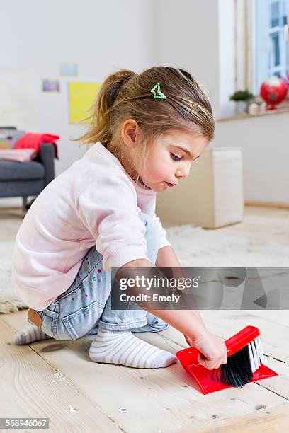 girl sweeping floor with brush at home - barre class fotografías e imágenes de stock