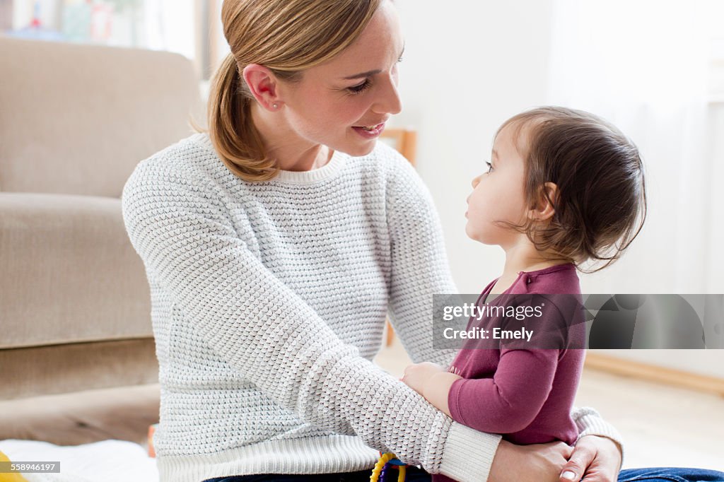 Mother and baby boy sitting face to face