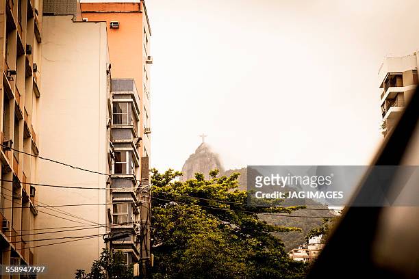 low angle view of misty christ the redeemer, rio de janeiro, brazil - rio de janeiro street stock pictures, royalty-free photos & images