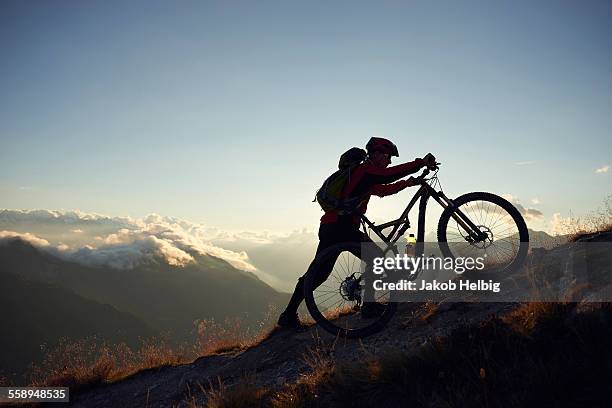 mountain biker pushing bike uphill, valais, switzerland - 上り坂 ストックフォトと画像